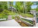 Landscaped yard with a charming water feature and steps leading to the house at 7753 Ivy Dr, Nineveh, IN 46164