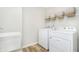 Well-lit laundry room equipped with modern appliances and ample storage, optimizing functionality and convenience at 778 Adler Dr, Avon, IN 46123