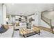 Open-concept living room with a modern kitchen view, featuring a comfortable sofa and stylish decor at 778 Adler Dr, Avon, IN 46123