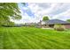 Large, well-maintained backyard with lush green lawn and mature trees at 7835 Quail S Rdg, Plainfield, IN 46168