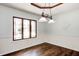 Bright dining room featuring wainscotting, hardwood floors, and a large window at 7835 Quail S Rdg, Plainfield, IN 46168