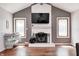 Close up of fireplace in living room with hardwood floors and natural light from surrounding windows at 7835 Quail S Rdg, Plainfield, IN 46168