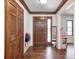 Welcoming foyer featuring hardwood floors, front door with stained glass, and natural light from the window at 7835 Quail S Rdg, Plainfield, IN 46168