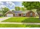 Charming brick ranch-style home boasts lush green lawn and attached two car garage in a residential neighborhood at 7835 Quail S Rdg, Plainfield, IN 46168