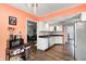 Open concept kitchen showcasing white cabinets, stainless steel appliances, and hardwood floors at 7835 Quail S Rdg, Plainfield, IN 46168