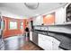 Clean kitchen area with white cabinets, stainless steel appliances, hardwood flooring, and seamless access to the dining area at 7835 Quail S Rdg, Plainfield, IN 46168