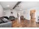 Bright, inviting living room with hardwood floors, ceiling fan, neutral paint, and seamless transition to the kitchen at 7835 Quail S Rdg, Plainfield, IN 46168