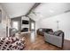 Spacious living room features hardwood floors, fireplace, ceiling fan, and abundant natural light from surrounding windows at 7835 Quail S Rdg, Plainfield, IN 46168