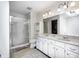 Bright bathroom with double sinks, shower, and skylight at 7835 Quail S Rdg, Plainfield, IN 46168