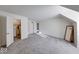 Attic with trim, modern gray carpeting, natural light, sloped ceilings, and doorways to other rooms at 8065 Bayberry Ct, Indianapolis, IN 46250