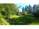 Lush backyard featuring a well-manicured lawn, mature trees and manicured landscaping at 8065 Bayberry Ct, Indianapolis, IN 46250