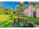 Landscaped backyard with greenery, mature trees and a brick facade on house at 8065 Bayberry Ct, Indianapolis, IN 46250
