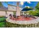 Backyard featuring a brick patio, mature trees, and stone retaining wall at 8065 Bayberry Ct, Indianapolis, IN 46250