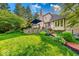 Landscaped backyard featuring a brick patio, well-manicured grass and mature trees at 8065 Bayberry Ct, Indianapolis, IN 46250