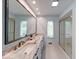 Bathroom featuring a double sink vanity, marble countertops, tiled floors, and walk in shower with glass door at 8065 Bayberry Ct, Indianapolis, IN 46250