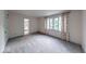 Bedroom with gray carpet, trim, floral curtains, and a view to an adjoined bathroom at 8065 Bayberry Ct, Indianapolis, IN 46250