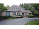 Charming brick home featuring dormer windows, manicured landscaping, and a paved driveway at 8065 Bayberry Ct, Indianapolis, IN 46250
