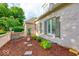 Exterior view of the home with a brick wall, bench, and attractive landscaping at 8065 Bayberry Ct, Indianapolis, IN 46250