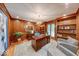 Wood-paneled office with custom built-ins, a large desk, and a comfortable seating area at 8065 Bayberry Ct, Indianapolis, IN 46250