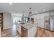 Modern kitchen with stainless steel appliances, granite countertops, eat-in island and wooden flooring at 8065 Bayberry Ct, Indianapolis, IN 46250