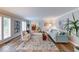 Bright living room features hardwood floors, large windows with shutters, and an opening to the dining room at 8065 Bayberry Ct, Indianapolis, IN 46250