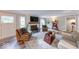 Comfortable living room featuring a fireplace, wood-look floors, and ample seating at 8065 Bayberry Ct, Indianapolis, IN 46250
