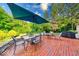 Brick patio featuring a grill, firepit, patio furniture, and shade at 8065 Bayberry Ct, Indianapolis, IN 46250
