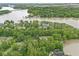 Aerial view displays a lakeside community with tree-lined streets and waterfront properties at 809 Iron Bridge Rd, Cicero, IN 46034