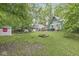 Expansive backyard featuring a shed, fire pit, and verdant trees at 809 Iron Bridge Rd, Cicero, IN 46034