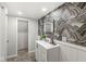 Stylishly designed bathroom with patterned wallpaper, modern vanity, and neutral wall color at 809 Iron Bridge Rd, Cicero, IN 46034