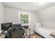 Cozy bedroom with natural light, a single bed, and a desk area, perfect for work or study at 809 Iron Bridge Rd, Cicero, IN 46034