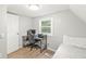 This bedroom includes a small workspace, natural light, and neutral wall color at 809 Iron Bridge Rd, Cicero, IN 46034
