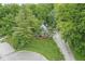 Exterior view showcases a charming home with a quaint front porch and surrounded by lush trees at 809 Iron Bridge Rd, Cicero, IN 46034