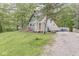 A-frame house with a gravel driveway, front deck, and mature trees, offering a cozy and private retreat at 809 Iron Bridge Rd, Cicero, IN 46034