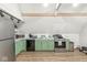 Modern kitchen with green cabinets, stainless steel appliances, and a clean, minimalist design at 809 Iron Bridge Rd, Cicero, IN 46034