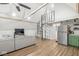 Open living space featuring a spiral staircase, modern sofa, and a kitchen with stainless steel appliances at 809 Iron Bridge Rd, Cicero, IN 46034
