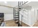 Unique spiral staircase leading to a loft area, complemented by hardwood floors at 809 Iron Bridge Rd, Cicero, IN 46034