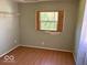Cozy bedroom with natural light, a neutral color palette, and laminate wood flooring at 909 Hickory St, Anderson, IN 46012