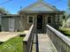 Charming single-story home with a textured exterior, accessible ramp, and a cozy, covered front porch at 909 Hickory St, Anderson, IN 46012