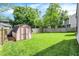 Spacious backyard with lush green lawn and storage shed at 9255 Fireside Dr, Indianapolis, IN 46250