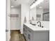 Beautiful bathroom with double sinks, a large mirror, and an open doorway to the toilet and shower at 9255 Fireside Dr, Indianapolis, IN 46250
