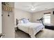 Comfortable bedroom with a ceiling fan, a soft bed, a treadmill, and a window with natural light at 9255 Fireside Dr, Indianapolis, IN 46250