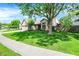 Attractive home with a spacious front yard, mature tree, and a two-car garage at 9255 Fireside Dr, Indianapolis, IN 46250