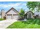 Charming home with a two-car garage, well-manicured lawn, and mature landscaping at 9255 Fireside Dr, Indianapolis, IN 46250