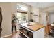 Kitchen island features storage, decor and is complimented by a bright sunny window at 9255 Fireside Dr, Indianapolis, IN 46250