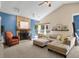 Spacious living room with stone fireplace and large windows bringing in natural light at 9255 Fireside Dr, Indianapolis, IN 46250