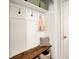 Stylish mudroom with board and batten detail, storage bench, hooks and overhead storage at 9255 Fireside Dr, Indianapolis, IN 46250
