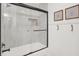 Clean shower with a glass door, white subway tile, and shelving for shampoo and body wash at 9255 Fireside Dr, Indianapolis, IN 46250