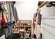 Organized walk-in closet with hanging clothes, shelf, and shoes creating neat storage space at 9255 Fireside Dr, Indianapolis, IN 46250