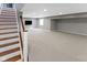 Basement stairway that leads to a spacious finished basement with neutral carpet and ample lighting at 10155 Landis Blvd, Fortville, IN 46040